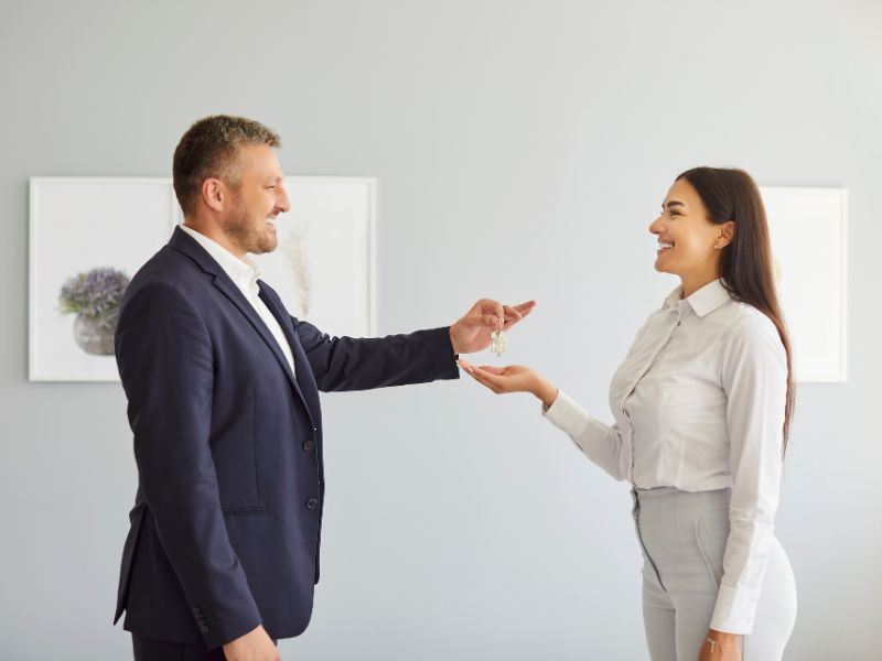 devojka uzima ključ od stana od investitora i veselo se smeju